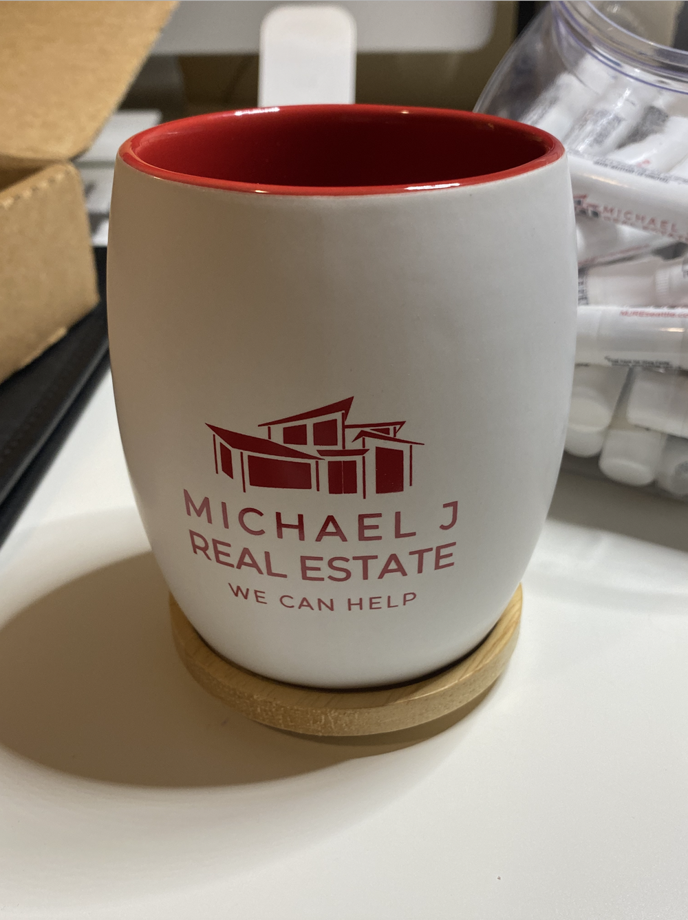 a white and red mug with red text on it